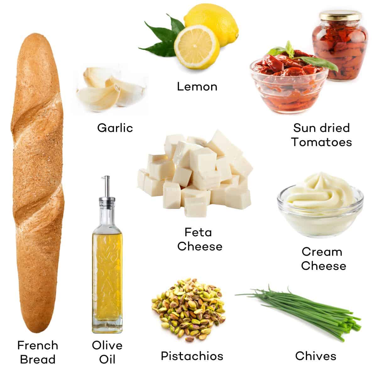 Ingredients for whipped feta bruschetta - lemon, garlic, sun dried tomatoes, feta cheese, cream cheese, french bread, olive oil, pistachios, chives.  