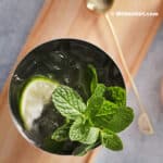 A glass of mocktail with lime and mint.