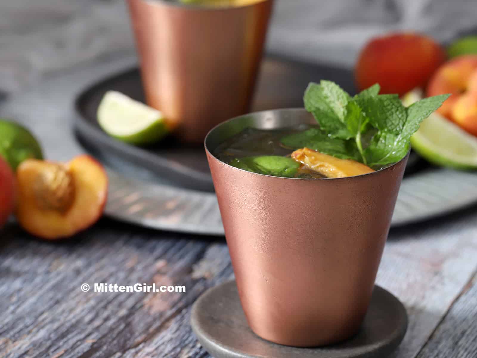 A copper cup of peach Moscow mule. 