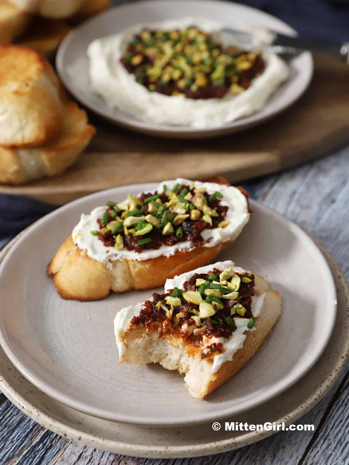 Pieces of whipped feta bruschetta with sun dried tomatoes. 
