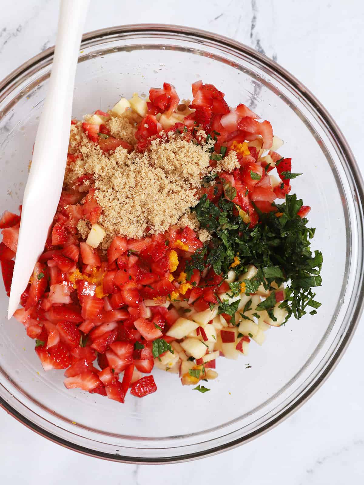 A bowl of fruit salsa ready to be mixed together.