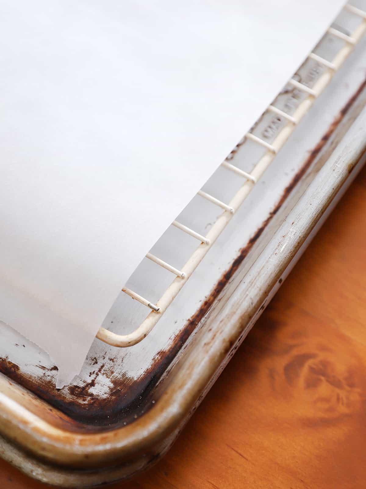 A baking sheet with a wire rack and parchment paper.