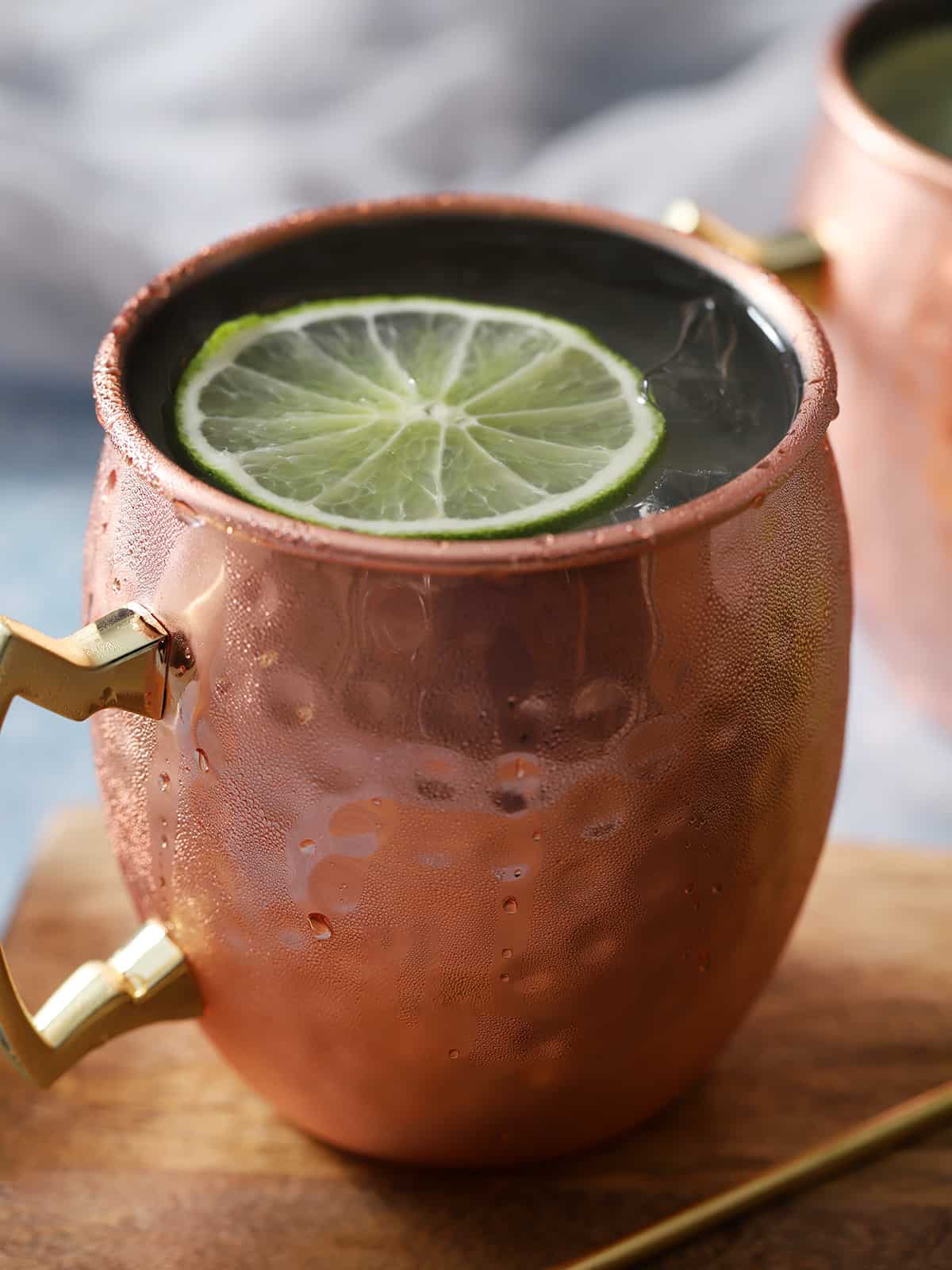 Copper mug filed with Moscow Mule cocktails.