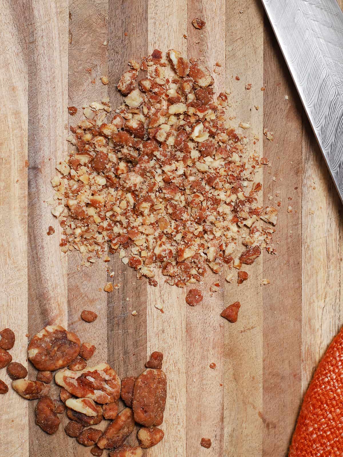 Diced candied nuts on a wooden cutting board. 