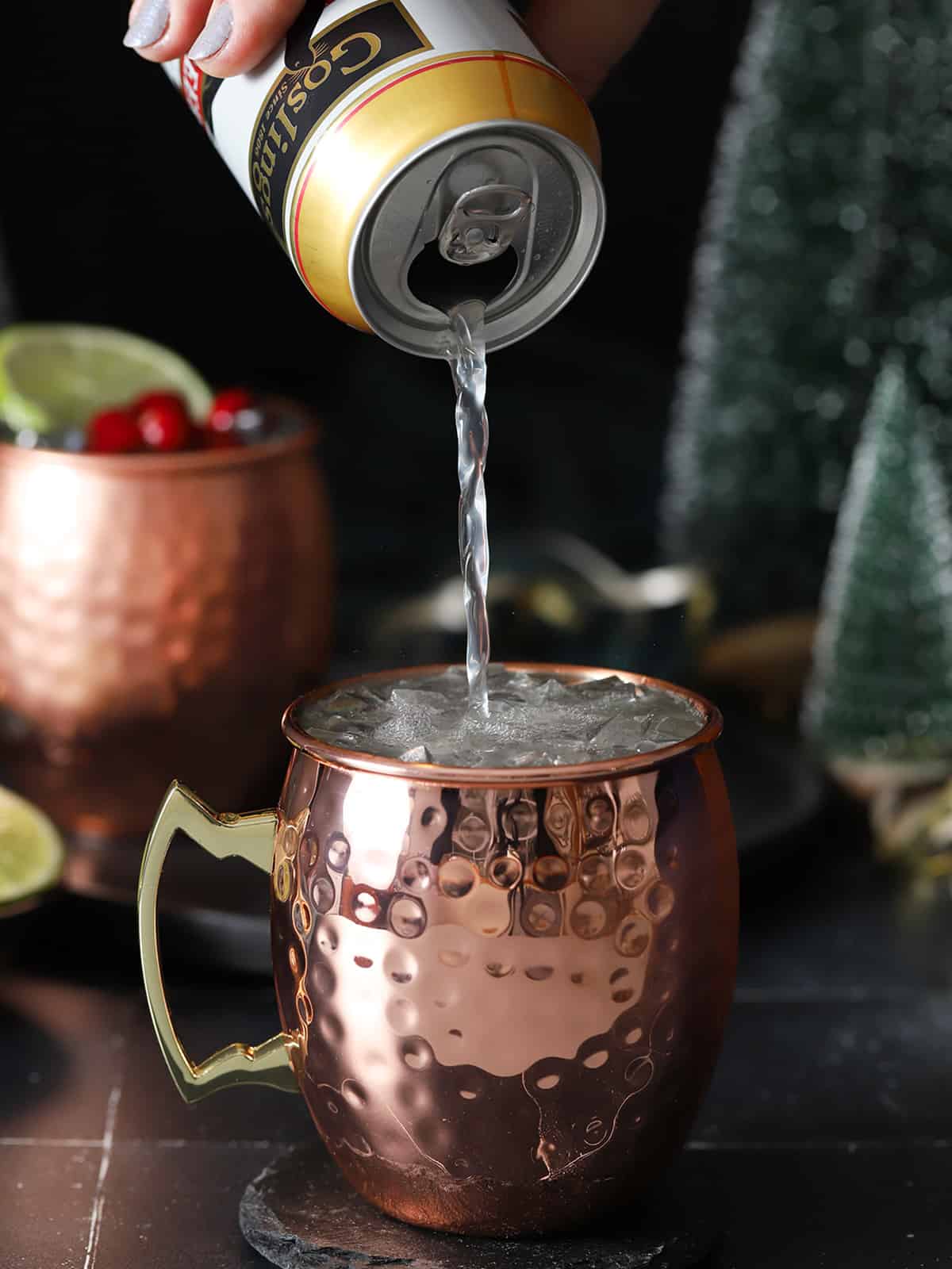 Ginger beer being poured into a copper mug. 