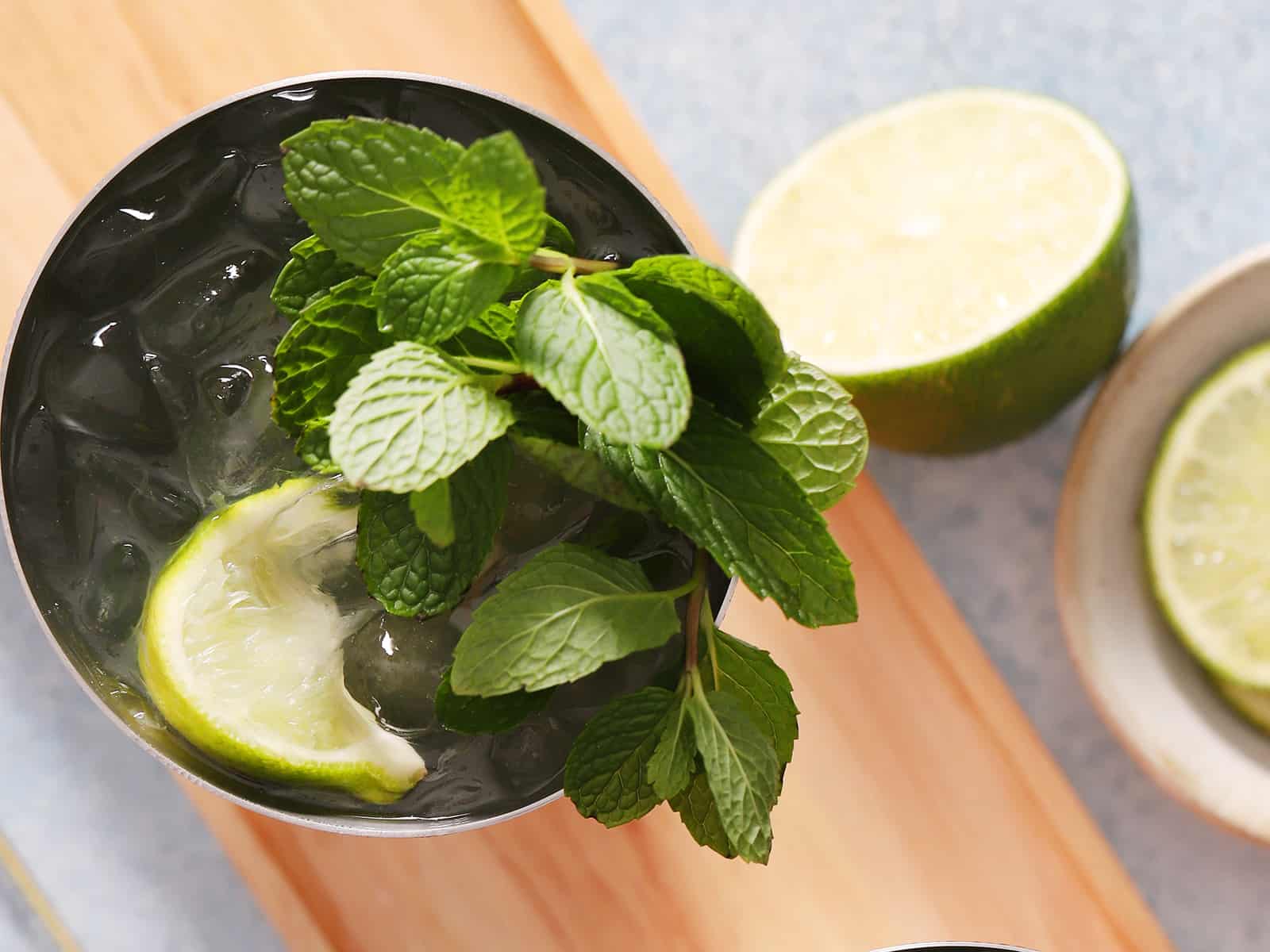 A large group of mint leaves and lime in a mocktail. 