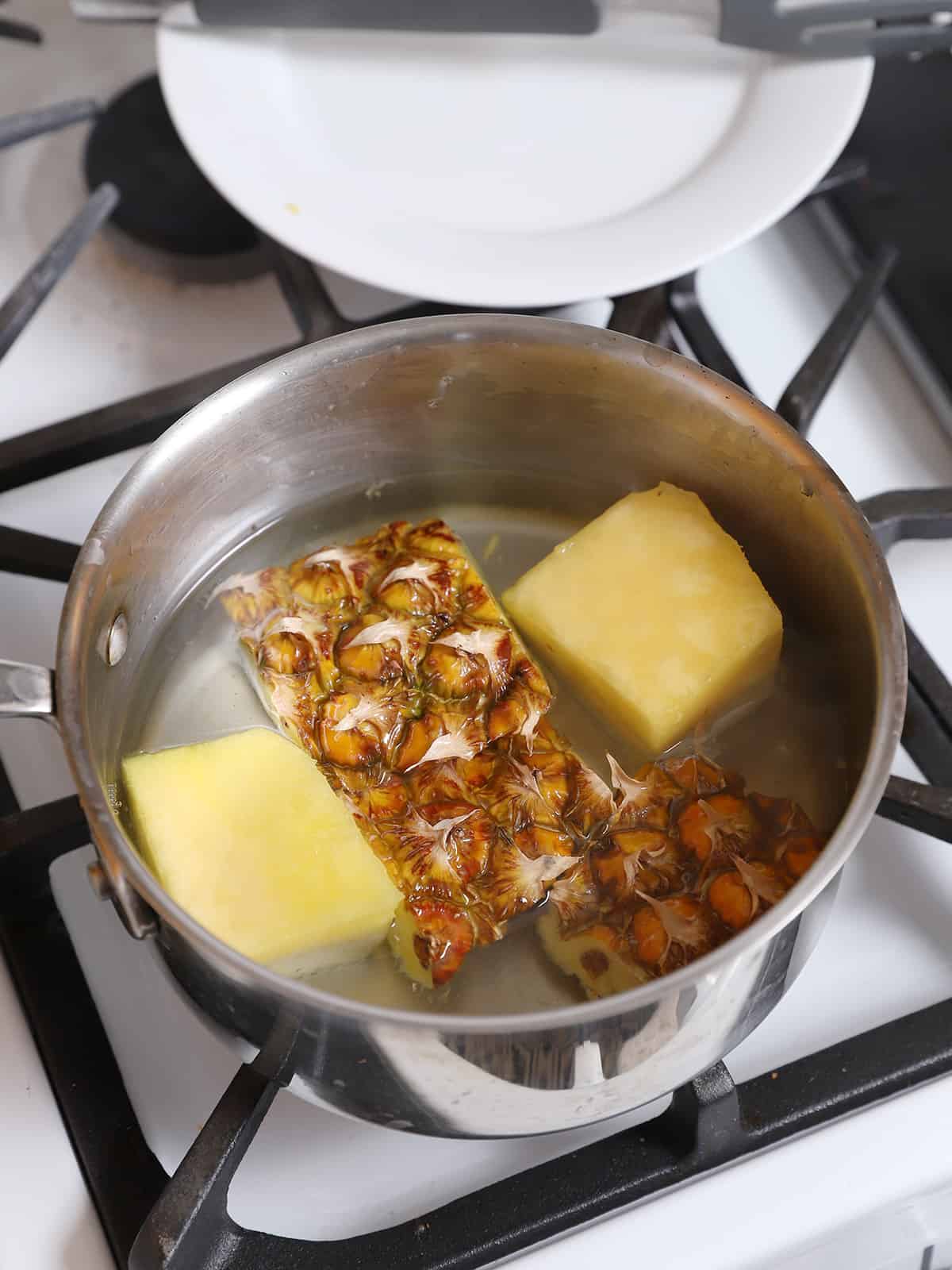A pot of pineapple syrup on the stove. 