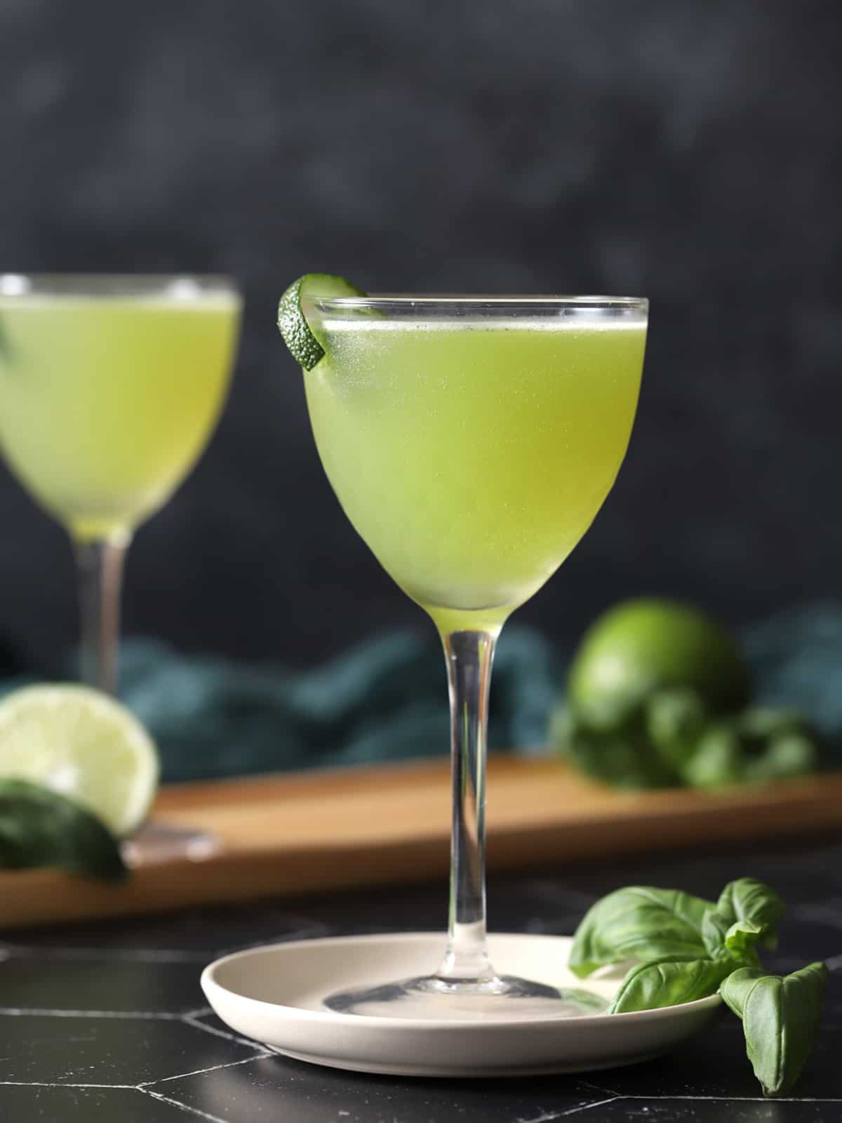A glass of basil gimlet cocktail. 