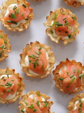 A plate of smoked salmon appetizer bites.