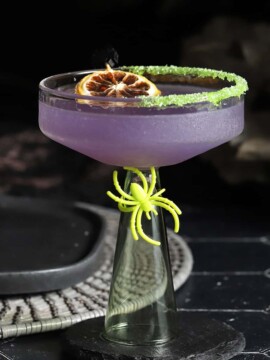 A martini glass filled with witches brew cocktail.