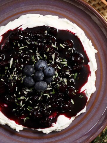 A plate filled with blueberry and goat cheese dip.