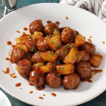 A platter full of Hawaiian meatballs with pineapple.