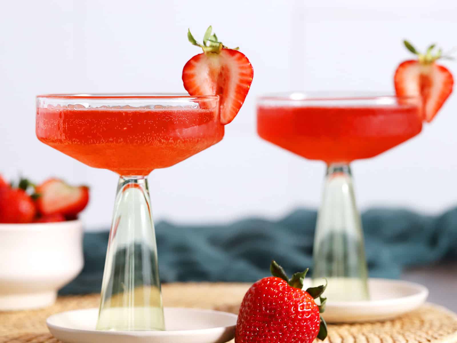 Glasses of Strawberry Bourbon Cocktail garnished with fresh strawberries.