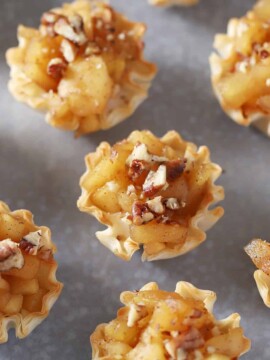 Mini apple pie bites on a platter.