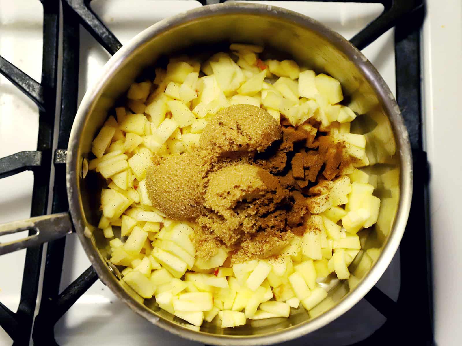 A pot full of apples, brown sugar, lemon juice, salt, and cinnamon.