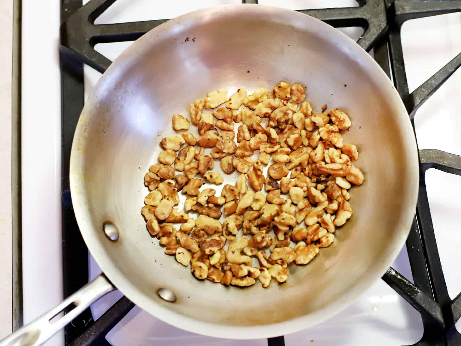 A pan of walnuts on the stove.
