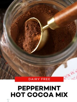 A tablespoon in a mason jar of peppermint hot cocoa mix.